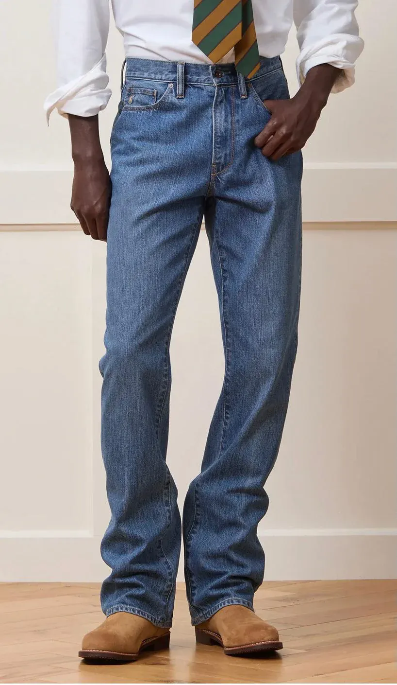 Image showing person wearing classic blue jeans, white dress shirt, striped tie and brown leather boots