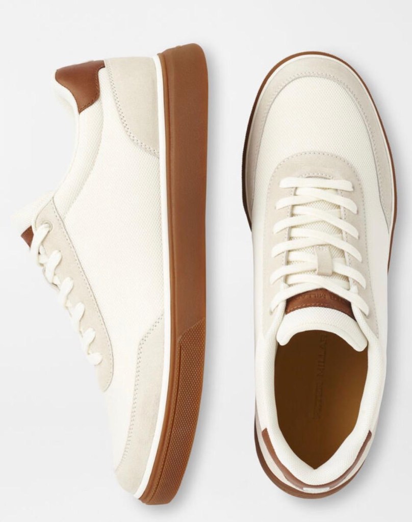 Image showing cream-colored casual sneakers with brown rubber soles and leather accents displayed from top and side view